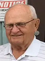 Image of Gary Holmes, an older man with glasses, dressed in a white shirt as the President of Glidden Board of Adjustment.