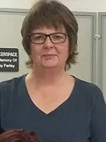 Woman named Julie in glasses and blue shirt.